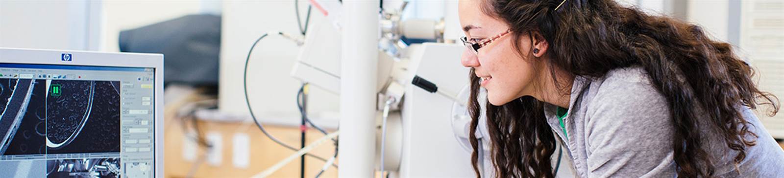 female student looking at testing equipment monitors