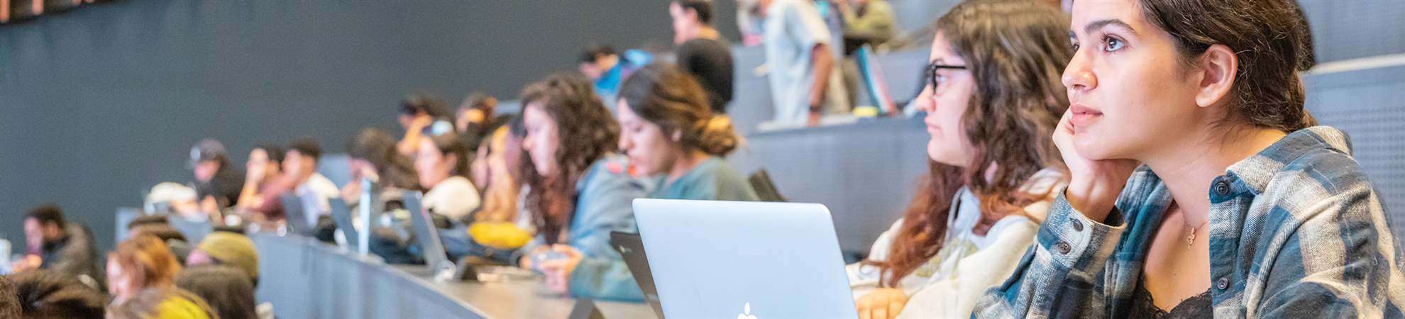 female student in front of her laptop looking at presentation